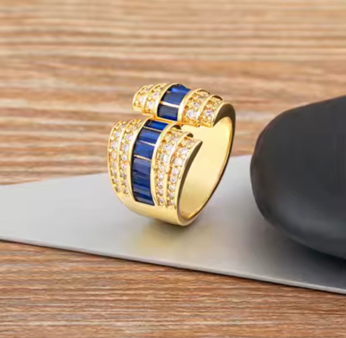 Gold tone open statement ring with baguette stones and clear cubic zirconia