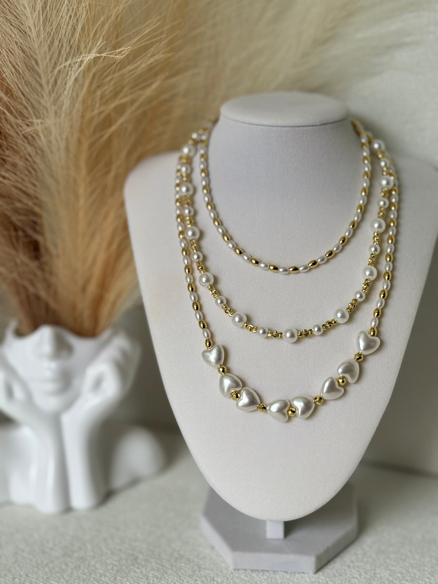 Three styles of synthetic pearl necklaces with 18K gold plated beads including oval pearl round pearl and heart pearl designs