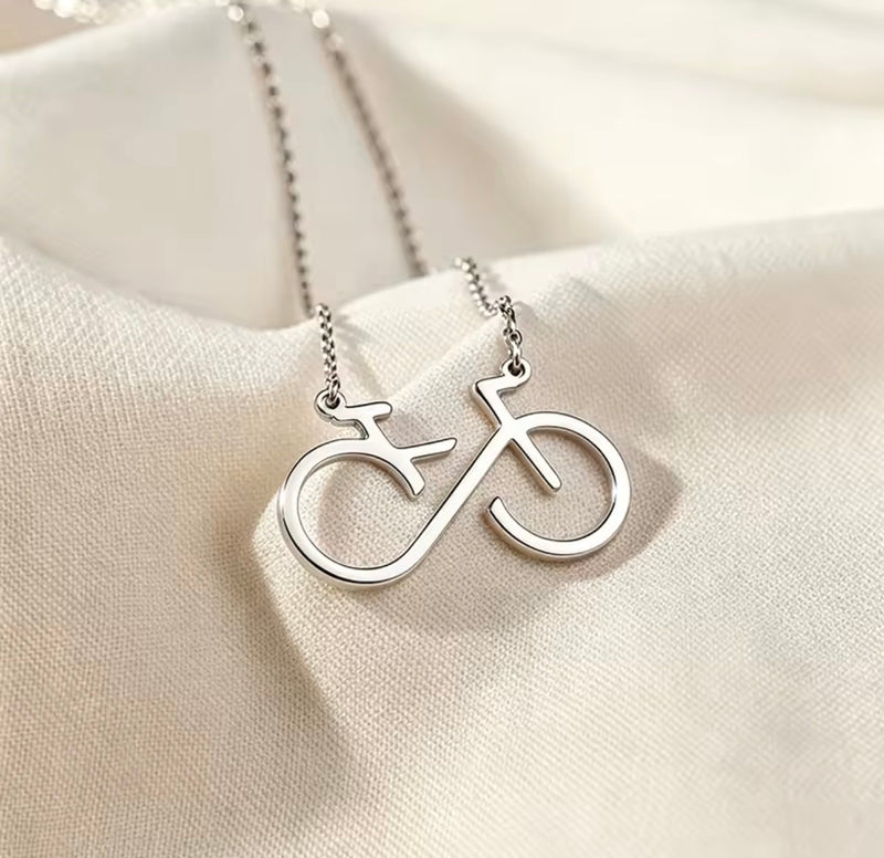 Infinity bicycle pendant necklace in stainless steel available in gold and silver