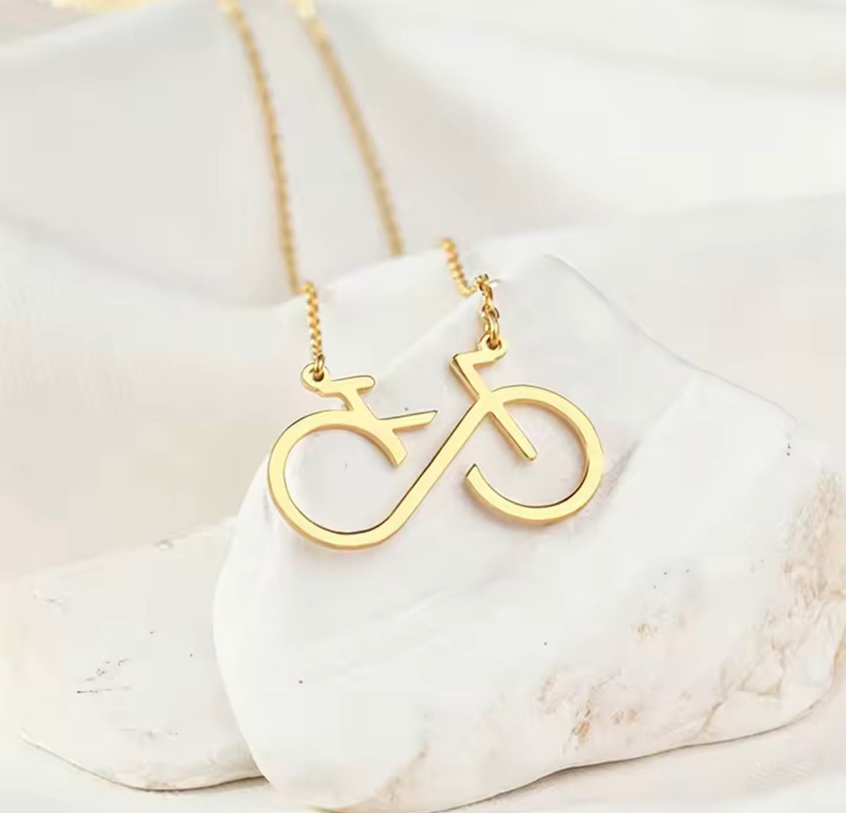 Infinity bicycle pendant necklace in stainless steel available in gold and silver