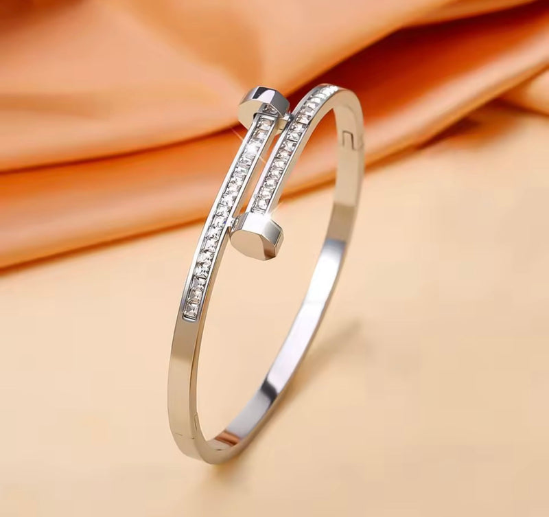 Stainless steel nail bangle bracelet with clear zirconia stones available in gold and silver
