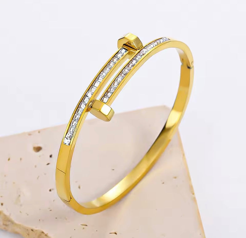 Stainless steel nail bangle bracelet with clear zirconia stones available in gold and silver