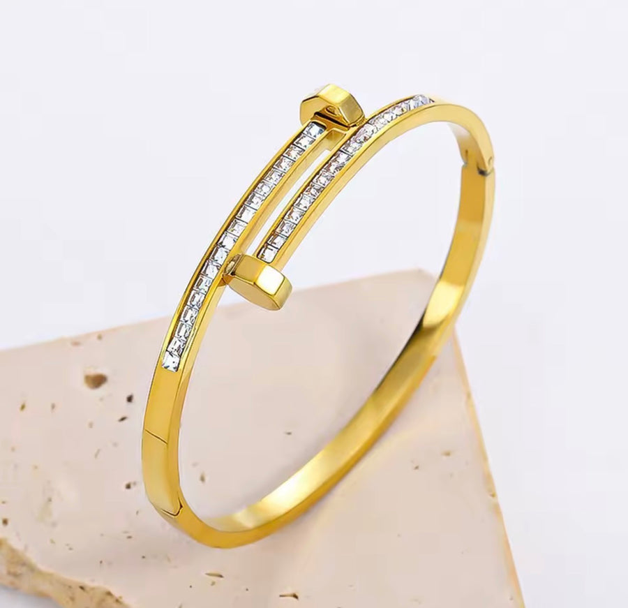 Stainless steel nail bangle bracelet with clear zirconia stones available in gold and silver
